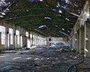 The interior of a run-down, abandoned industrial facility.