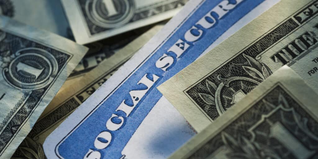 Social Security written in bold with cash spread around it.